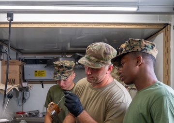 131st Bomb Wing Airmen practice interoperability with Marines in expeditionary kitchen