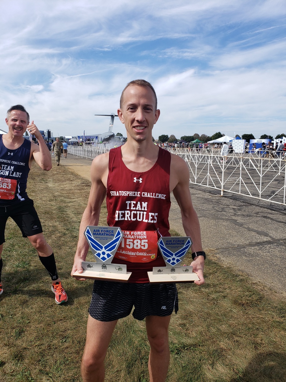 Maj. Brett Lechtenberg, 377th Comptroller Squadron director of operations, holds two trophies after completing the 27th Annual Air Force Marathon at Wright-Patterson Air Force Base.