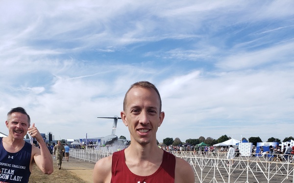 Maj. Brett Lechtenberg, 377th Comptroller Squadron director of operations, holds two trophies after completing the 27th Annual Air Force Marathon at Wright-Patterson Air Force Base.