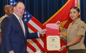MARINE CORPS MASCOT CPL CHESTY XVI RECEIVES GOOD CONDUCT MEDAL FROM SECRETARY OF THE NAVY