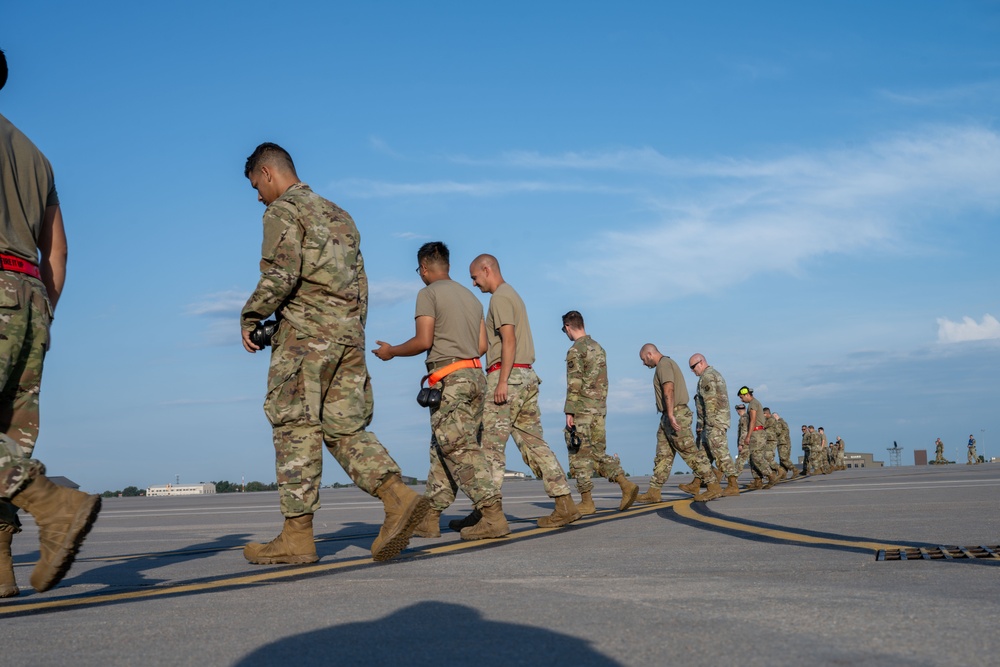 Maintenance Airmen sweep flightline for FOD