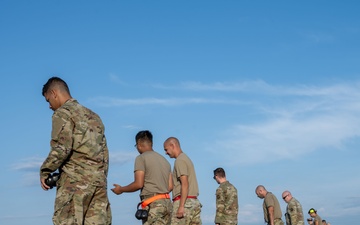 Maintenance Airmen sweep flightline for FOD