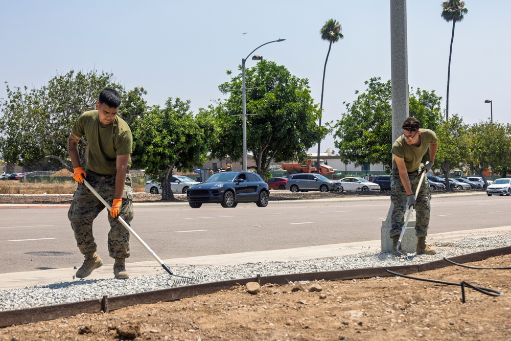 Marines and Sailors lay out rocks with a non-federal entity