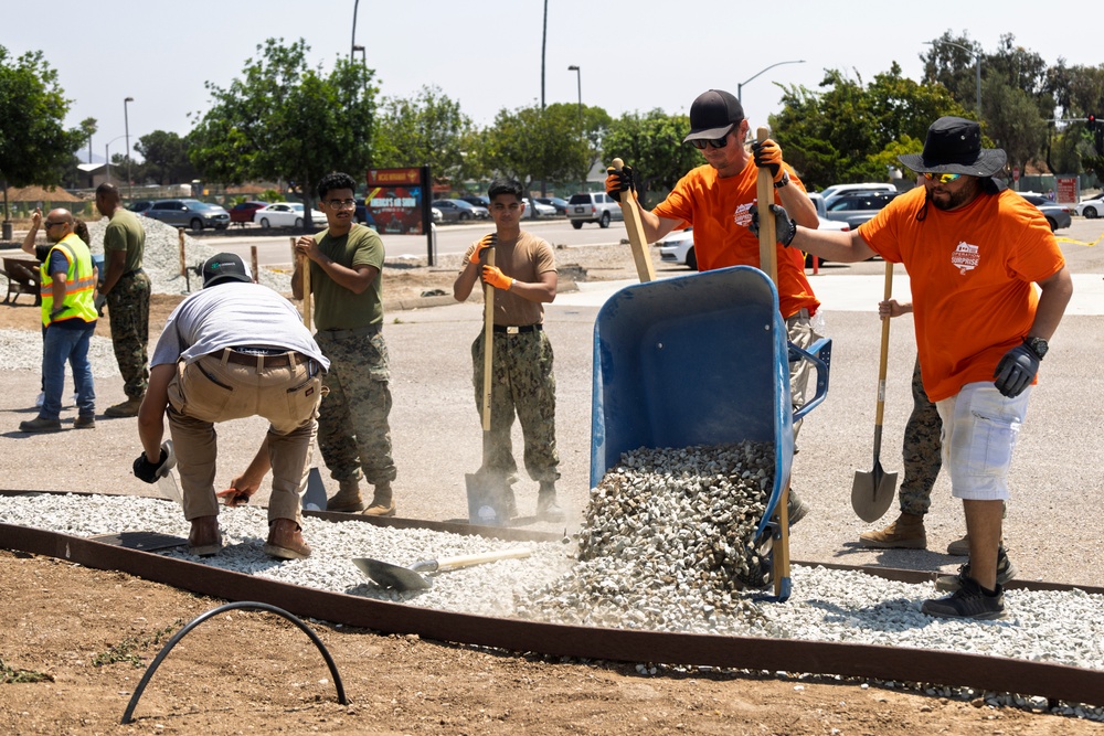 Marines and Sailors lay out rocks with a non-federal entity