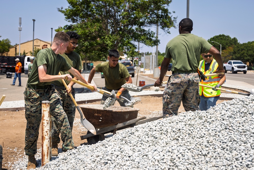 Marines and Sailors lay out rocks with a non-federal entity