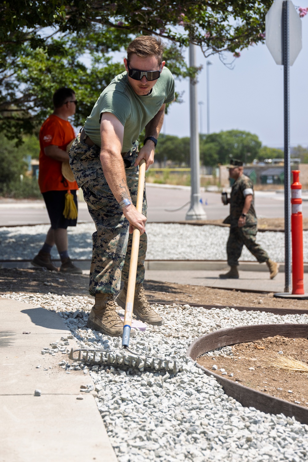 Marines and Sailors lay out rocks with a non-federal entity