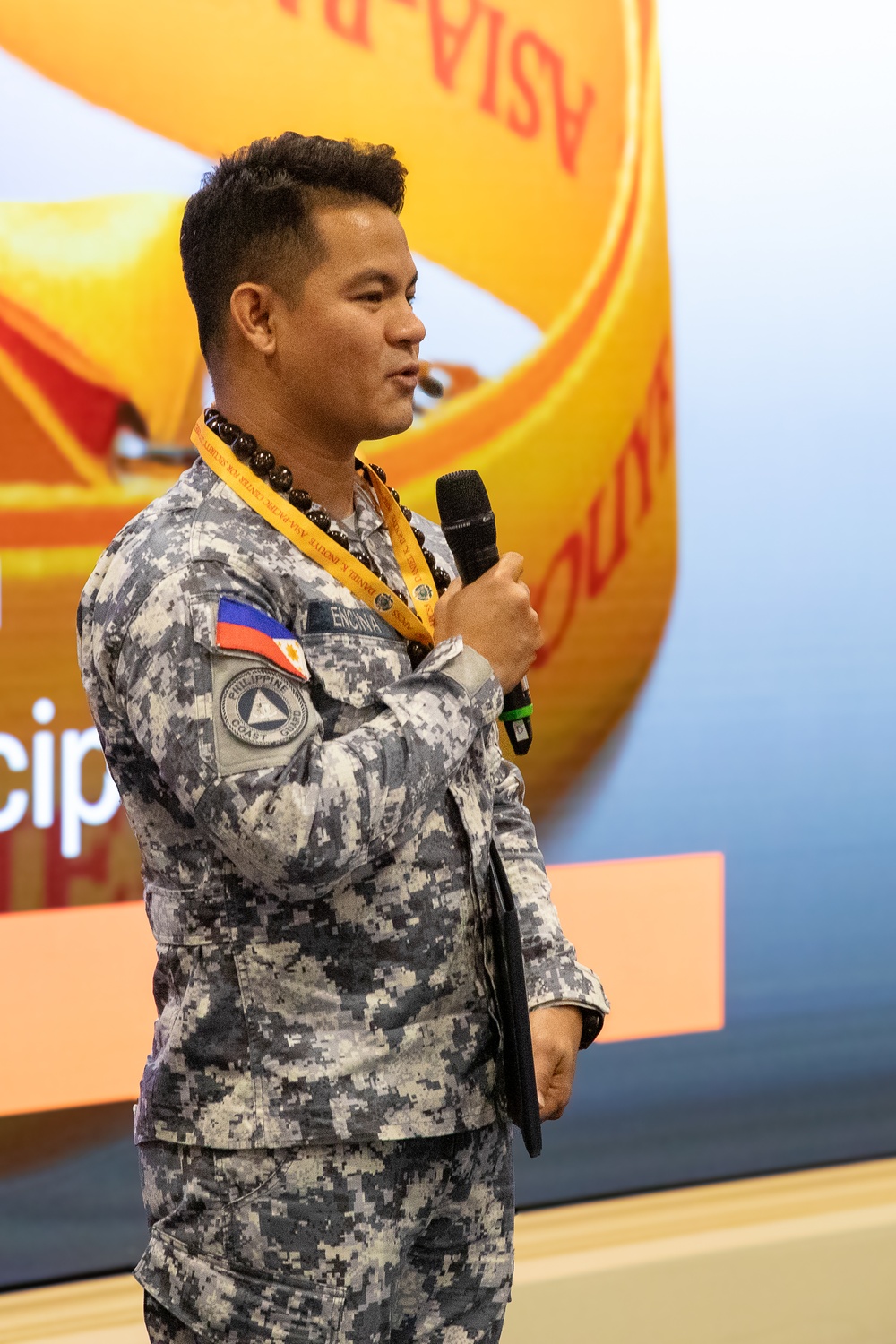 Cmdr. Michael John Encina Padua awarded the DKI APCSS Fellows Project Laulima lanyard