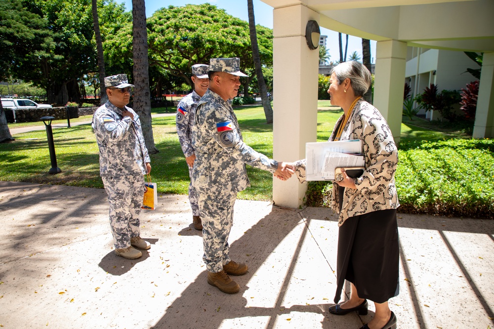 Cmdr. Michael John Encina Padua awarded the DKI APCSS Fellows Project Laulima lanyard