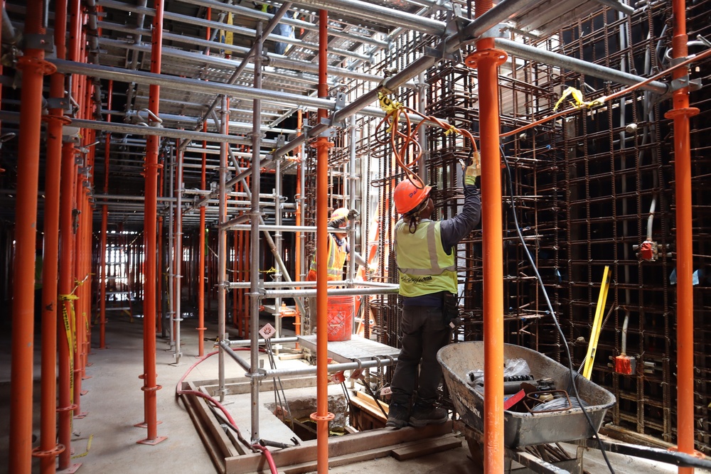 Construction Crew Prep A Worksite Under Scaffolding
