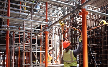 Construction Crew Prep A Worksite Under Scaffolding
