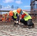 Crew Members Tie Rebar Ahead of a Concrete Pour