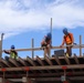 Construction Workers Build Safety Rails
