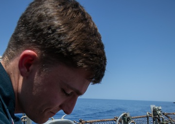 USS Gerald R. Ford (CVN 78) Sailor puts flight gear on working dog