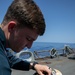 USS Gerald R. Ford (CVN 78) Sailor puts flight gear on working dog