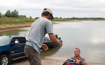 Garrison Dam team meets a paddling pal