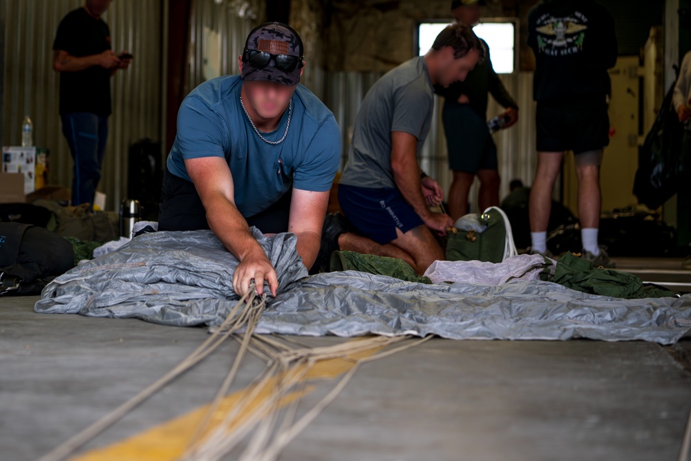 NSWG2 personnel prepare parachutes for AE25
