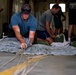 NSWG2 personnel prepare parachutes for AE25