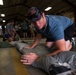 NSWG2 personnel prepare parachutes for AE25