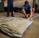 NSWG2 personnel prepare parachutes for AE25