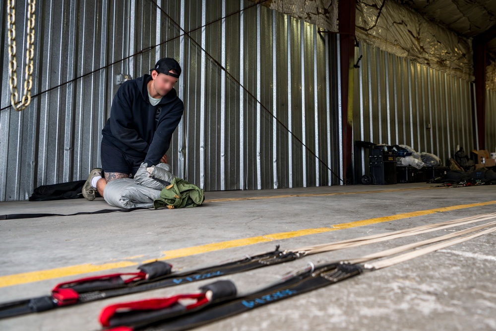 NSWG2 personnel prepare parachutes for AE25