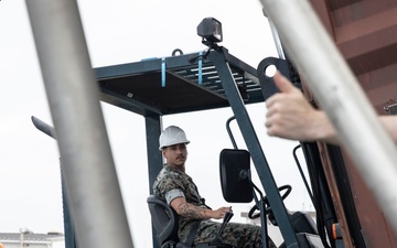 U.S. Marines receive cargo from USNS Guam