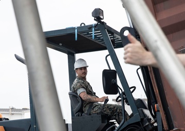 U.S. Marines receive cargo from USNS Guam