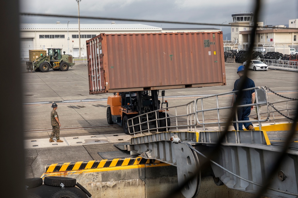 U.S. Marines receive cargo from USNS Guam