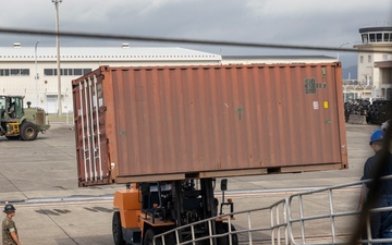 U.S. Marines receive cargo from USNS Guam