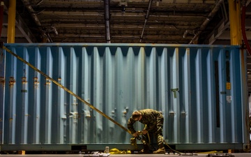 U.S. Marines receive cargo from USNS Guam