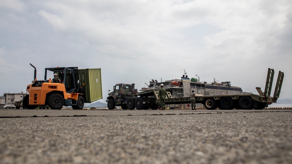 U.S. Marines receive cargo from USNS Guam