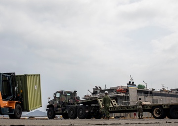 U.S. Marines receive cargo from USNS Guam