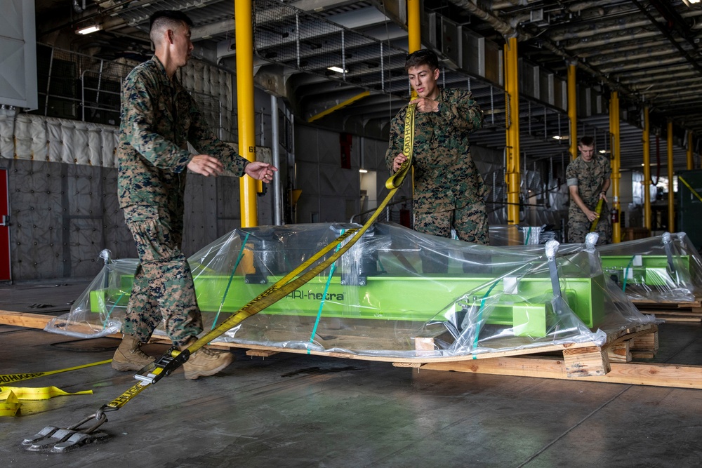 U.S. Marines receive cargo from USNS Guam