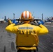 USS Gerald R. Ford (CVN 78) Sailor Signals To An F/A-18E Super Hornet