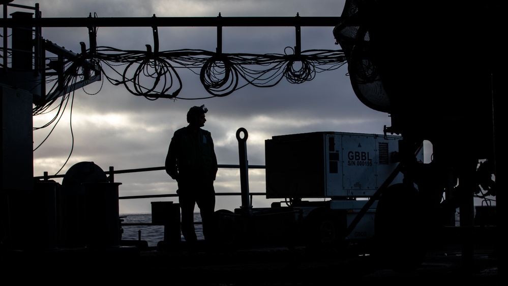 USS Gerald R. Ford (CVN 78) Sailor Observes Jet Engine Maintenance
