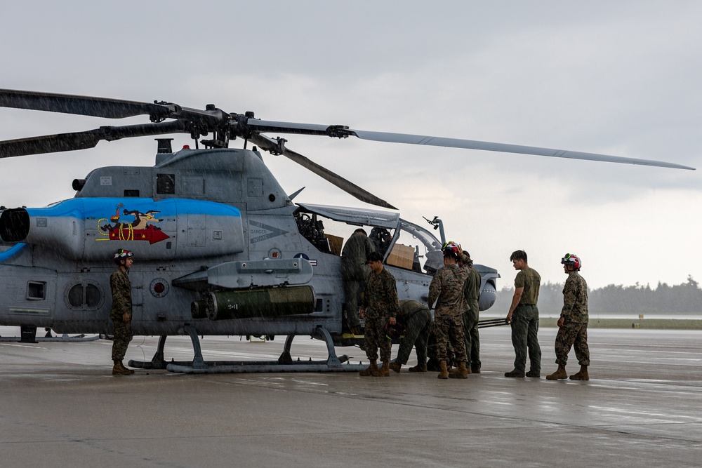 HMLA-775 Coyotes conduct flight line operations in the rain