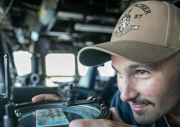 USS Mitscher (DDG 57) officer looks through navigational alidade