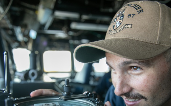 USS Mitscher (DDG 57) officer looks through navigational alidade