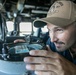 USS Mitscher (DDG 57) officer looks through navigational alidade