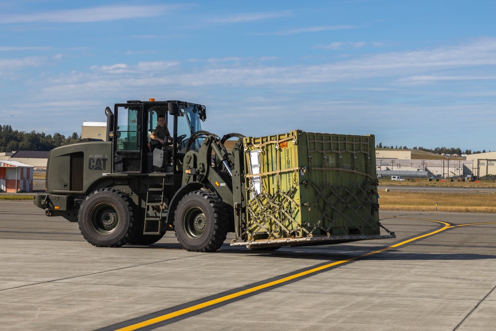 U.S. Marines with 3rd Bn., 4th Marines, move equipment and supplies during Arctic Edge 25