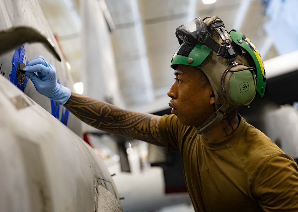 Strike Fighter Squadron 37 Sailor Conducts Maintenance