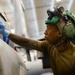 Strike Fighter Squadron 37 Sailor Conducts Maintenance