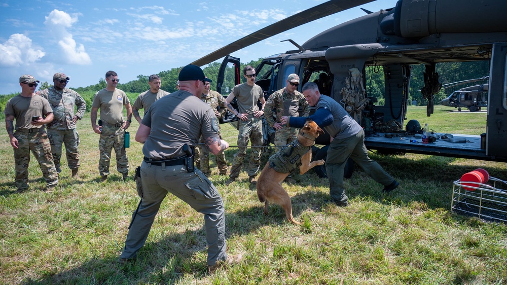 Maryland Army National Guardsmen engage with police K-9s during flight familiarization