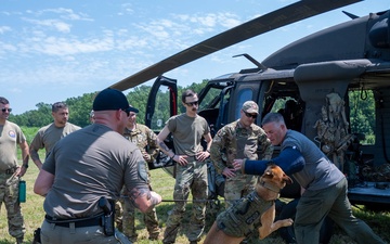Maryland Army National Guardsmen engage with police K-9s during flight familiarization