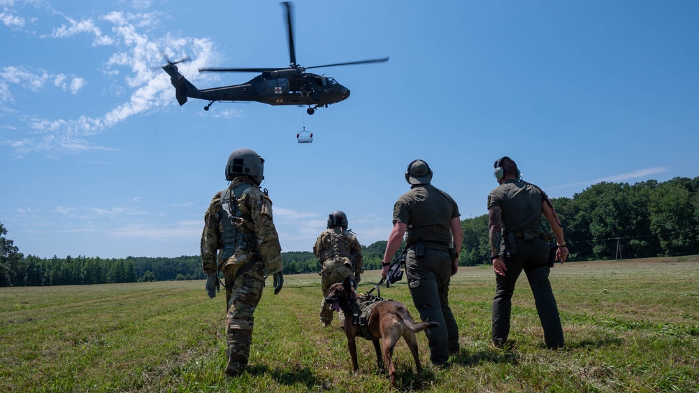 Maryland Army National Guardsmen engage with police K-9s during flight familiarization