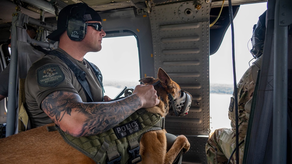 Maryland Army National Guardsmen engage with police K-9s during flight familiarization