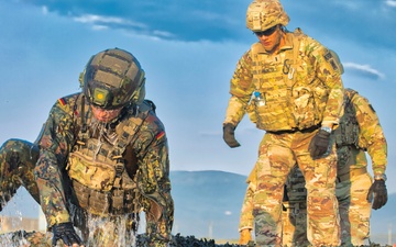 Mud, Muscle, and Multinational Might: German-Led 'Saulauf' Challenges NATO Troops and Builds Camaraderie