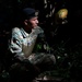 Panamanian and USMC members learn about flora and fauna during jungle survival course
