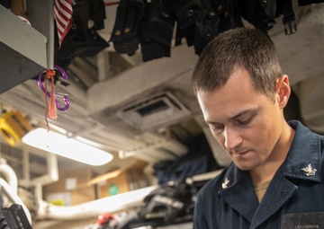 USS Mitscher (DDG 57) Sailor conducts MK-240 machine gun maintenance