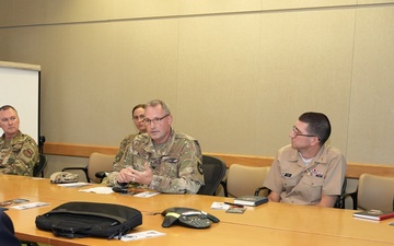 USUHS President talks with Tri-Service Dental Researchers