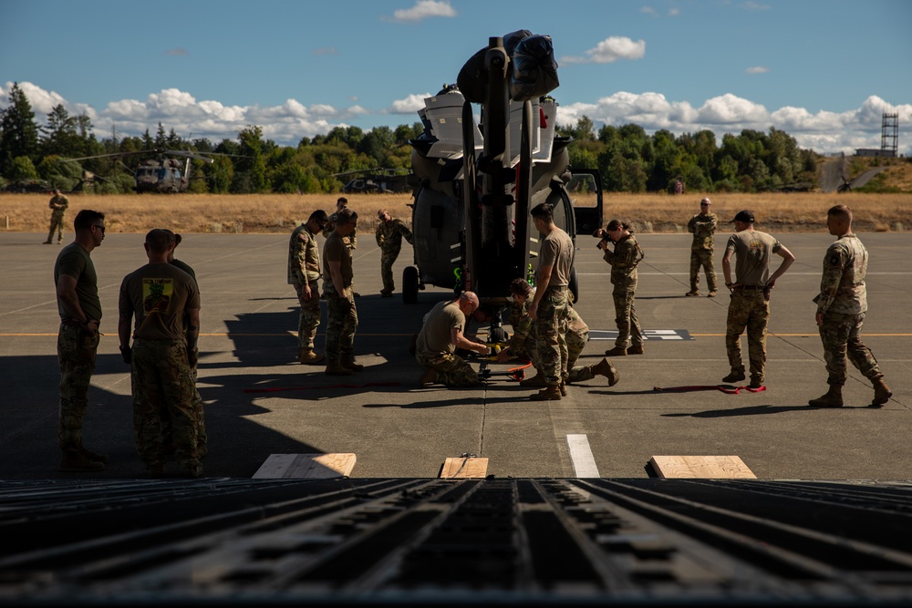 Checked baggage: Washington National Guard soldiers load Black Hawks into a C-17 Globemaster III